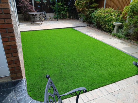 railway sleepers being used as artificial lawn frame